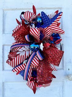 a patriotic wreath with red, white and blue bows