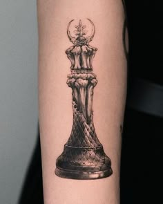 a black and white tattoo of a chess piece