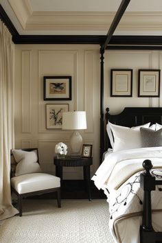 a bedroom with a four poster bed, chair and pictures on the wall above it