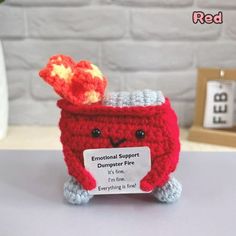 Adorable Crochet Dumpster Fire: Handmade with love, this adorable crochet dumpster fire doll is the perfect gift for anyone looking to add a of whimsy and humor to their desk decor. Its cute and unique design is sure to catch everyone's attention. Emotional Support Dumpster Fire: This handcrafted emotional support dumpster fire toy offers a lighthearted way to cope with challenges. Whether you need a little pick-me-up or want to bring a smile to someone's face, this plush doll is there to provid Diy Christmas Gifts Crochet, Crochet Emotional Support, Cool Desk Accessories, Crochet Stuffies, Fun Desk, Knitting Toy, Crochet Store, Buddy Gifts, Crochet Dreams