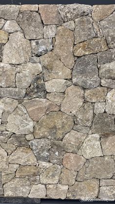 a stone wall with several different colored rocks