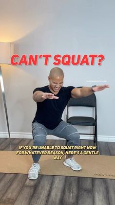 a man sitting on top of a yoga mat in front of a wall that says can't squat?