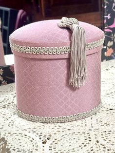 a pink hat box sitting on top of a table