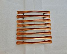 a wooden comb hanging from the side of a wall