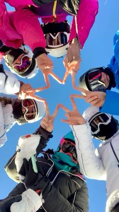 a group of people standing in a circle with their hands together