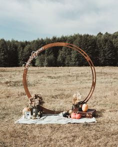 an outdoor ceremony setup in the middle of a field