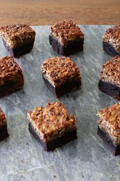 nine pieces of brownie sitting on top of a table