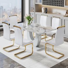 a marble dining table surrounded by white chairs