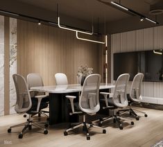 an office meeting room with white chairs and a large marble table in the middle of it