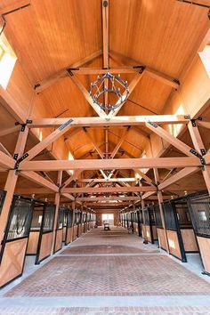 the inside of an open building with wooden walls and doors on either side of it