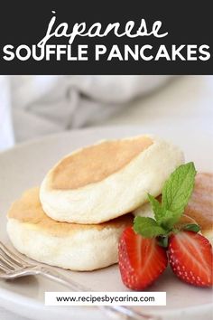 two pancakes on a plate with strawberries next to them and the words japanese souffle pancakes