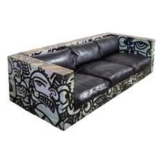 a black and white couch sitting on top of a wooden floor