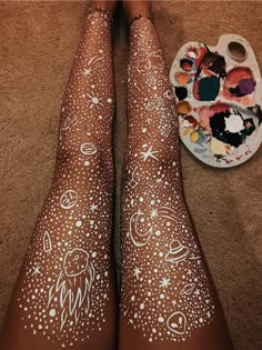 someone has their legs painted with white paint and some other things on the floor next to them