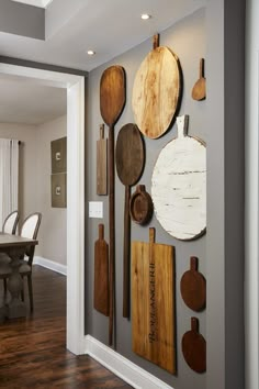 a kitchen wall with wooden spoons and spatulas hanging on it's side