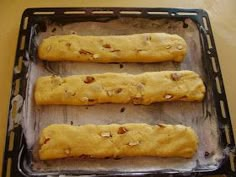 three long bread sticks sitting on top of a pan