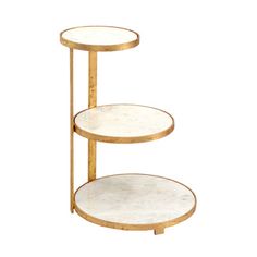 three tiered shelf with white marble top and gold metal frame, on an isolated background