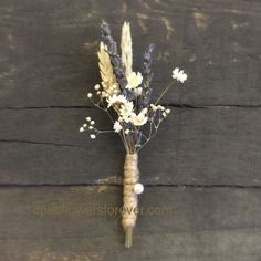 a bunch of dried flowers sitting on top of a wooden table