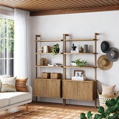 a living room filled with furniture and lots of greenery on top of wooden shelves