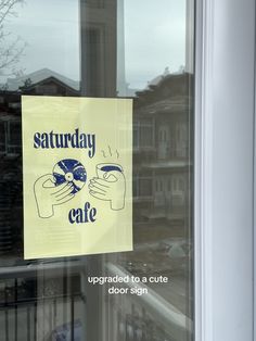 a sign is posted on the window of a cafe that says saturday cafe updated to a cute door sign