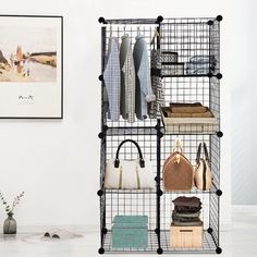 a black wire shelving unit with purses and handbags