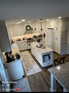 an open concept kitchen and dining room with white cabinets