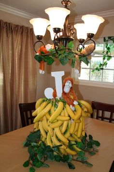 a bunch of bananas sitting on top of a table next to a chandelier