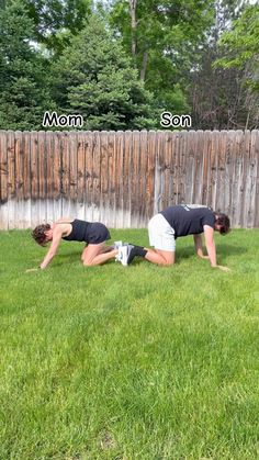 two people are doing push ups in the grass