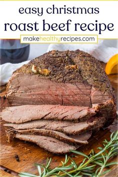 sliced roast beef on a cutting board with rosemary sprigs