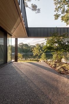 an empty patio with trees and water in the background