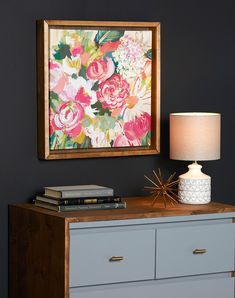 a painting hanging on the wall above a dresser