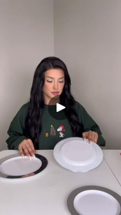 a woman sitting at a table with two plates