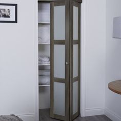 an open closet with white linens in it