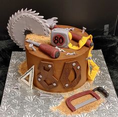 a cake that is shaped like a construction site with tools on top and in the shape of a circle