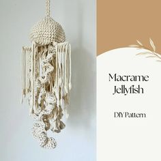 a crocheted dream catcher hanging from a wall next to a sign that says macrame jellyfish