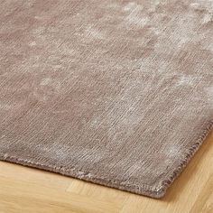 a brown rug on top of a wooden floor next to a wood flooring board