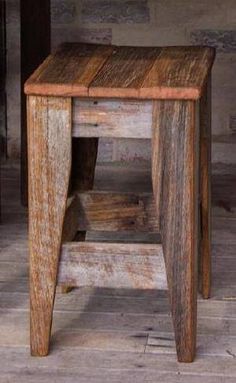 an old wooden stool sitting on top of a hard wood floor