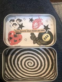 two tins that have different designs on them