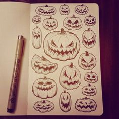 an open notebook with drawings of pumpkins and jack - o'- lantern faces