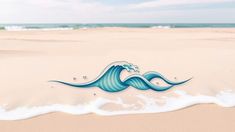 an ocean wave is on the sand at the beach