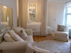 a living room filled with furniture and a large mirror