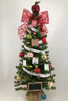 a small christmas tree decorated with ribbons and ornaments