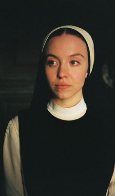 a woman wearing a nun costume and looking at the camera with a serious look on her face