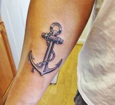 an anchor tattoo on the arm of a man