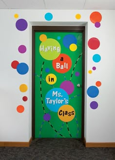 a classroom door decorated with balloons and saying having a ball in ms taylor's class