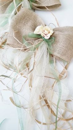 two burlap bows with flowers on them