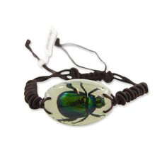 a bracelet with a green beetle on it