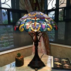 a stained glass lamp sitting on top of a table