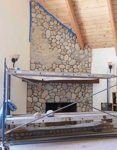 a stone fireplace being built in a living room