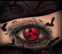 an eye tattoo on the arm with black ink and red light coming from its iris