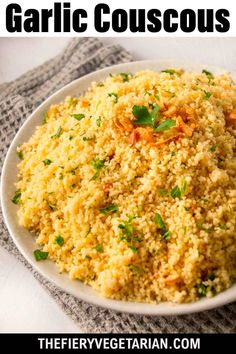 a white bowl filled with rice and garnished with parsley on the side